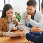 Couple meeting financial adviser for home investment contract