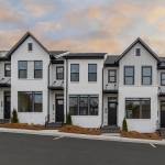 Image of exterior of semi-detached homes on a sunny day.