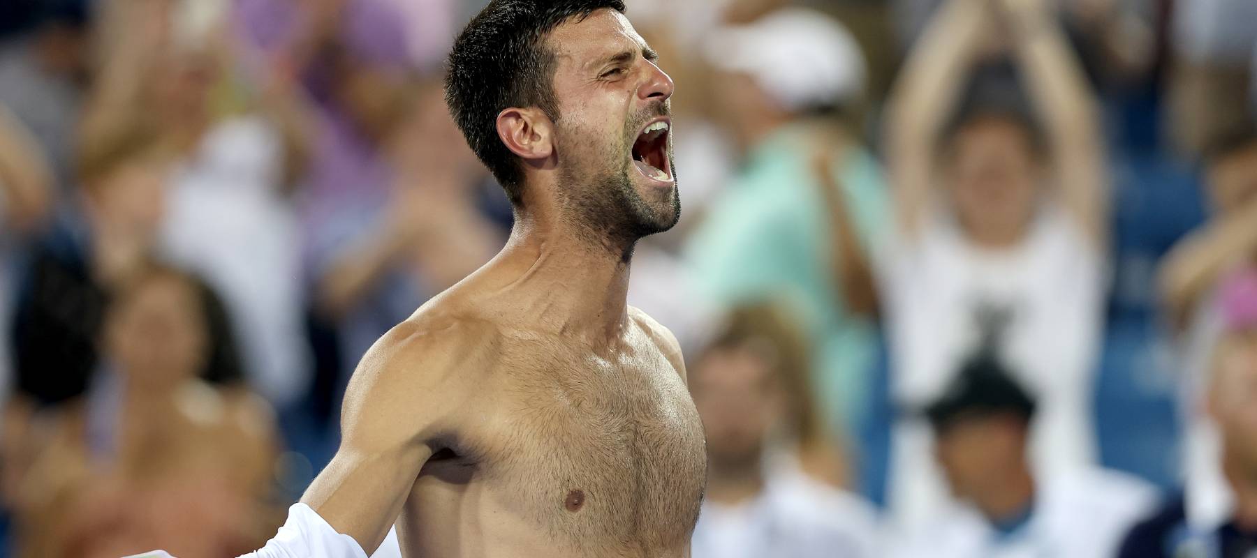 Novak Djokovic of Serbia tears his shirt off.