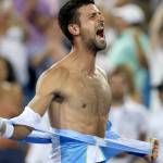 Novak Djokovic of Serbia tears his shirt off.