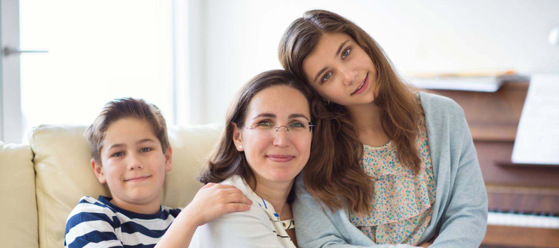 Portrait of pretty young mother with her two children adorable teenager daughter and son