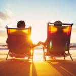 Retired couple enjoying beautiful sunset at the beach