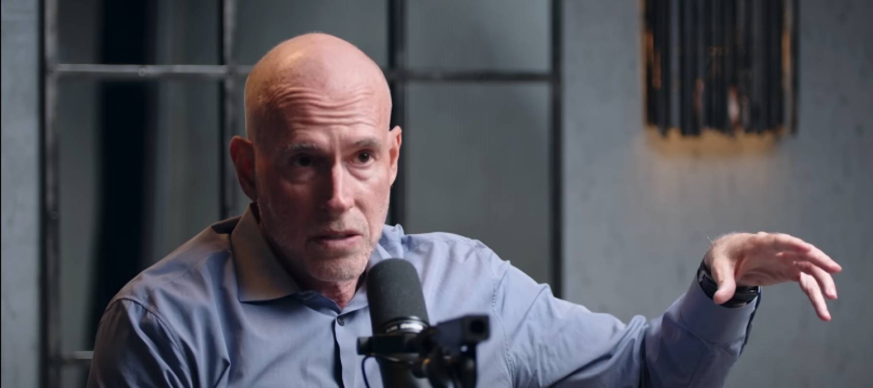 Scott Galloway seen speaking on set, gesturing.