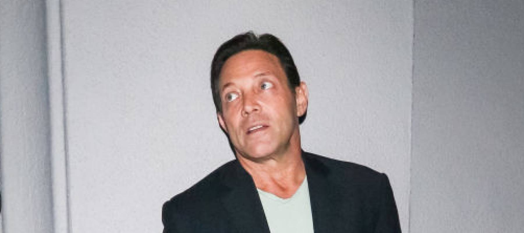 Jordan Belfort rolling his eyes and looking to the side, taken by surprise.