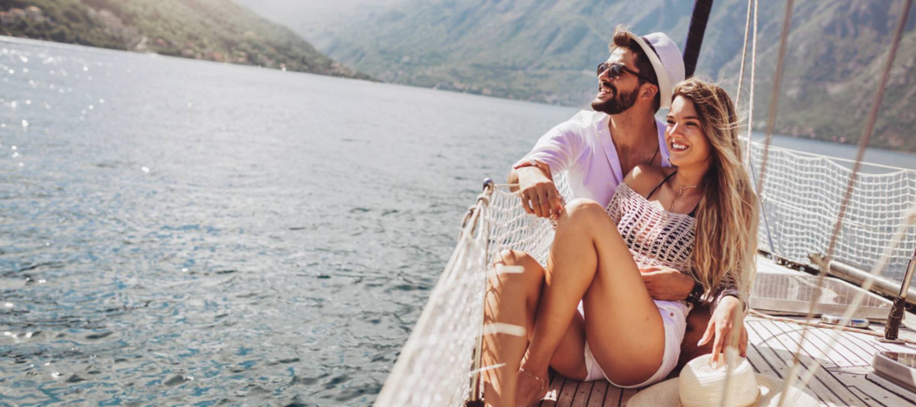 loving Caucasian couple spending happy time on a yacht at sea
