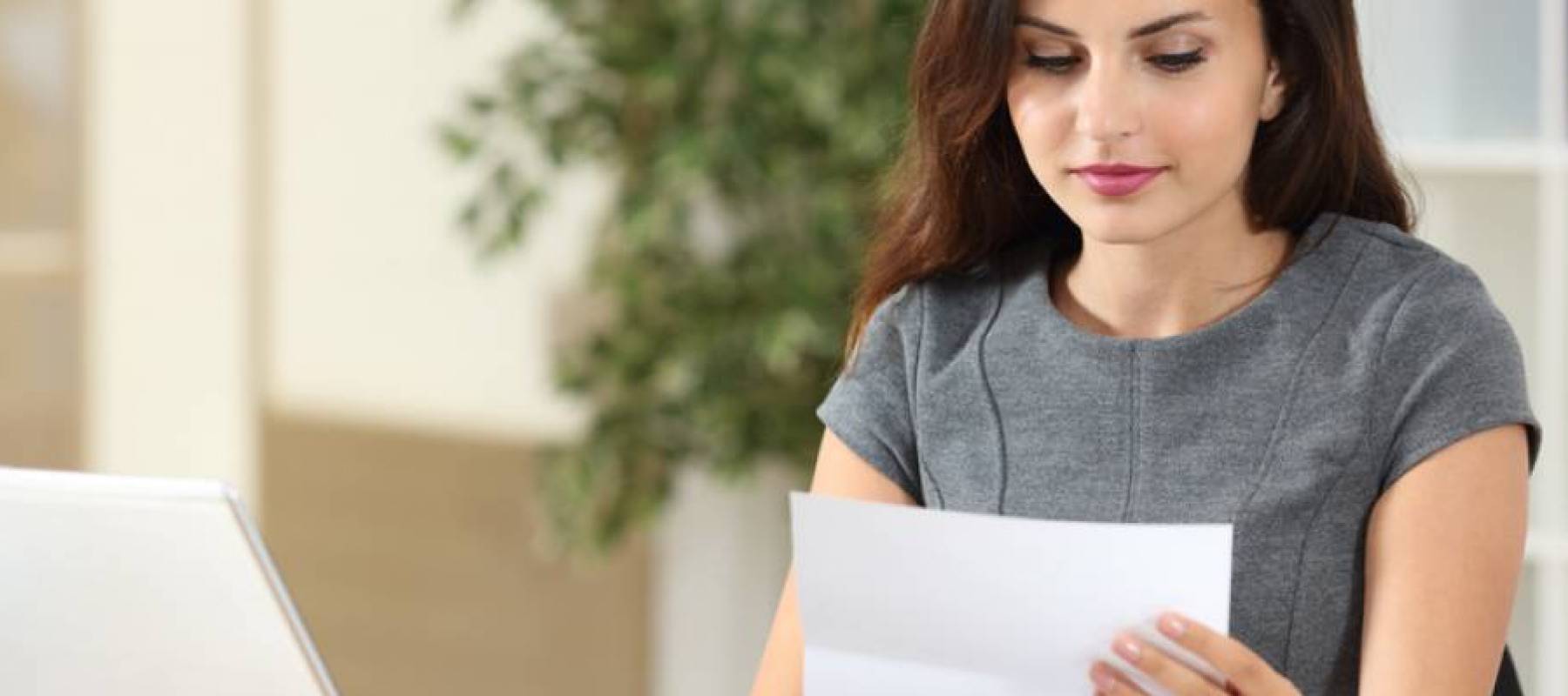 Woman reading a letter at her desk