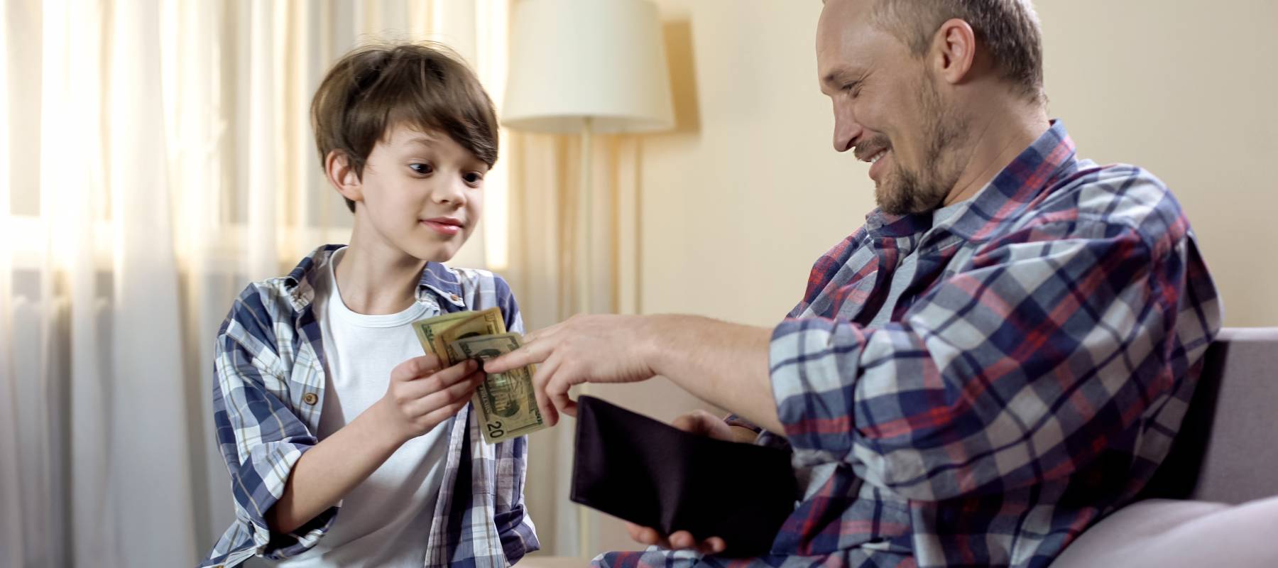 Child paying cash to father.