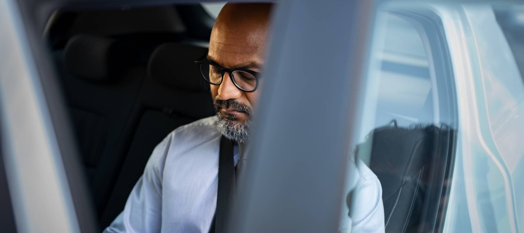 Middle-aged gentleman checking his credit score while buying a car.