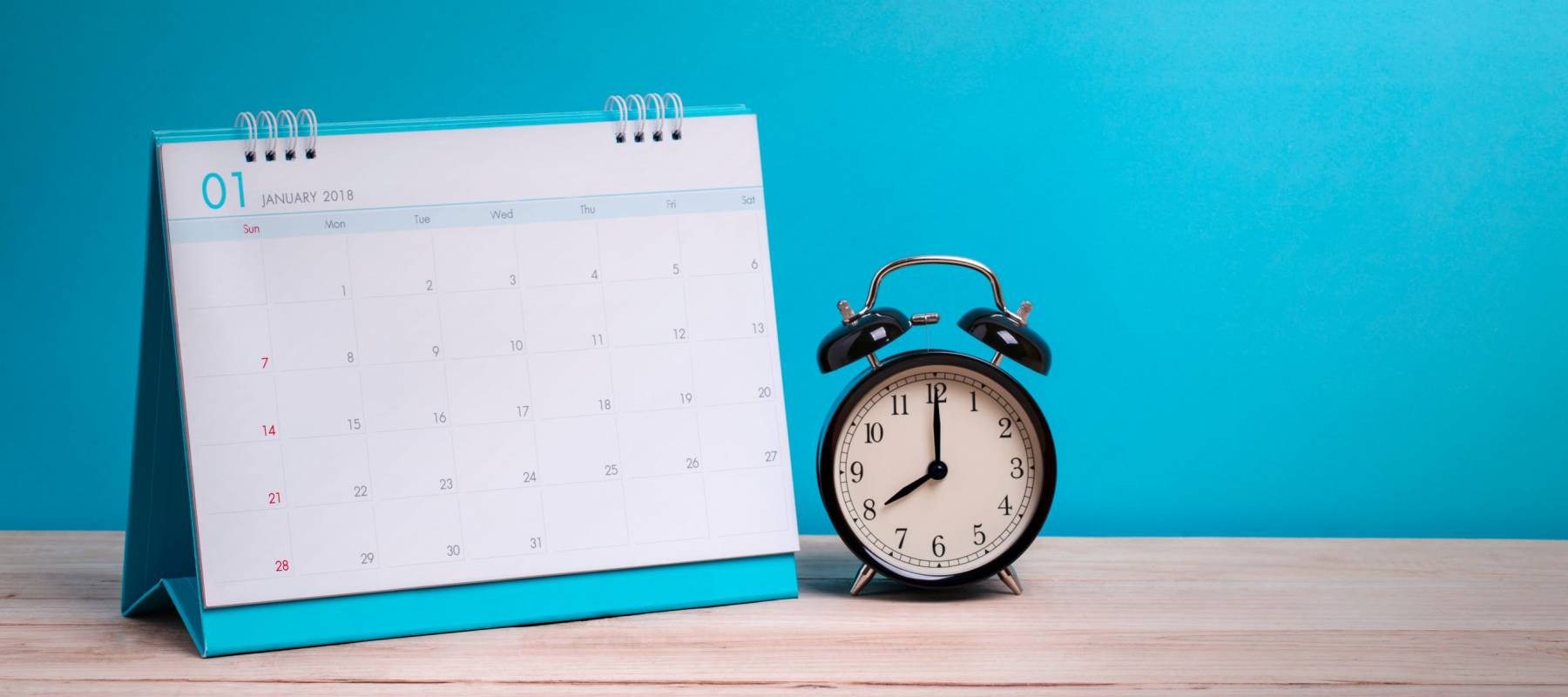 Vintage clock and calendar on wood, time concept