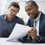 Older couple speaking with a retirement advisor