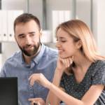 young couple at a bank speaking with advisor