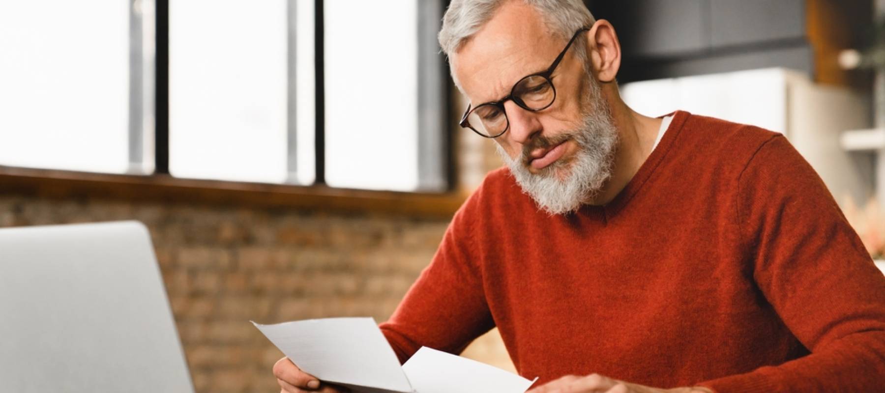 Mature middle-aged businessman freelancer man counting domestic bills