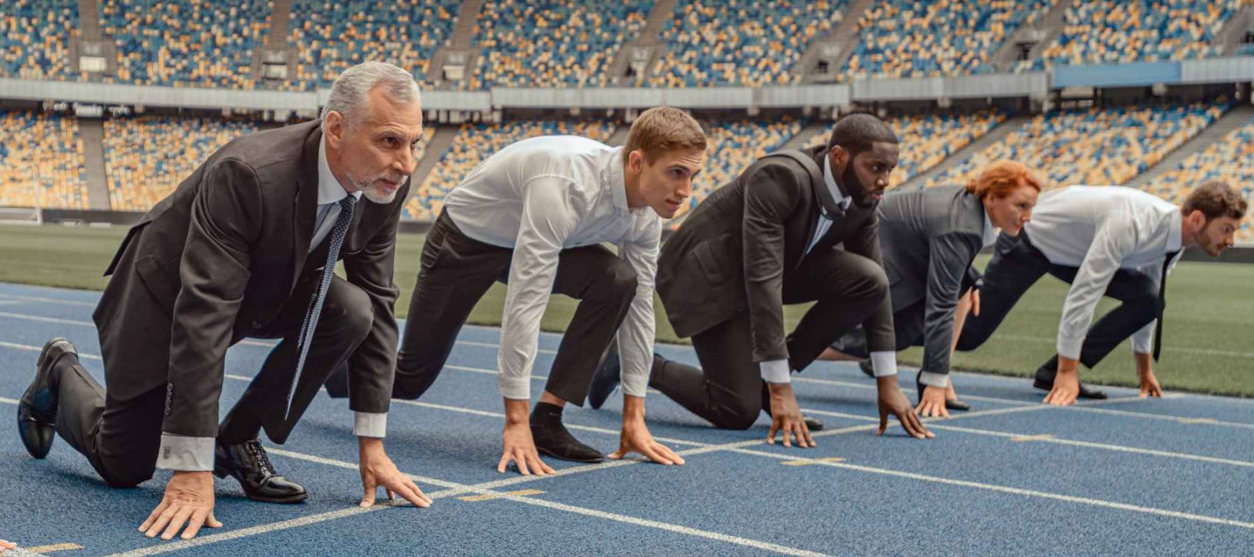 Business people standing ready for run sprint competition on race track