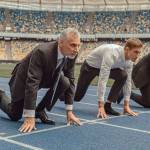 Business people standing ready for run sprint competition on race track