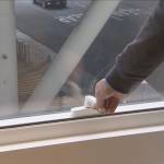 A resident use the window in Millennium Tower.