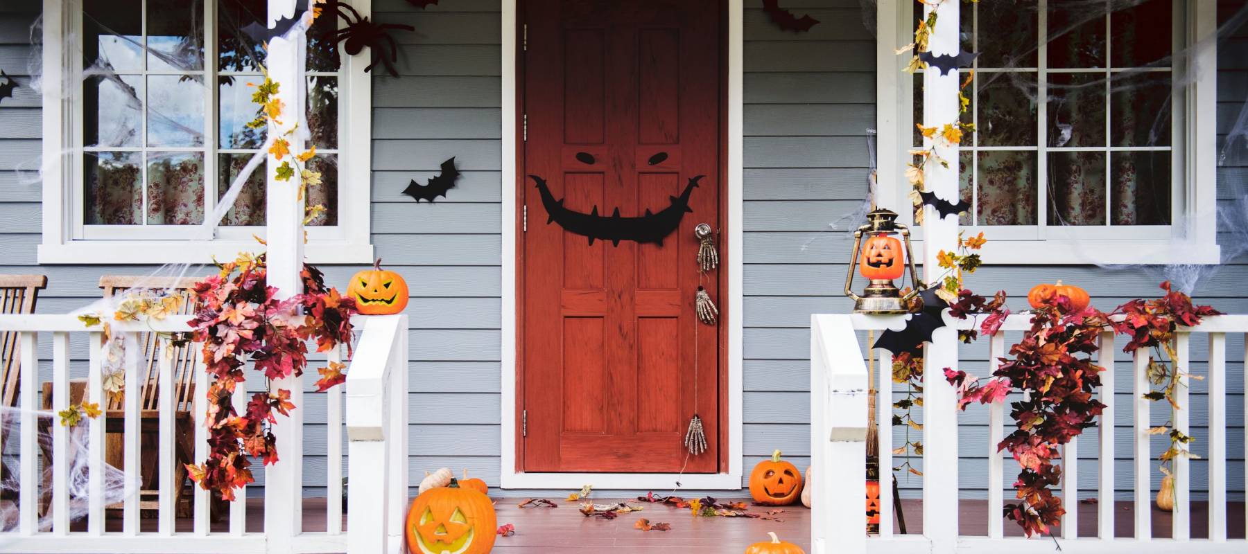Halloween pumpkins and decorations outside a house
