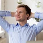Satisfied young man relaxing and feeling relieved