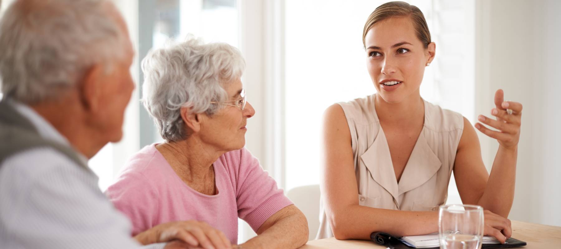 A young woman meets with an older couple.
