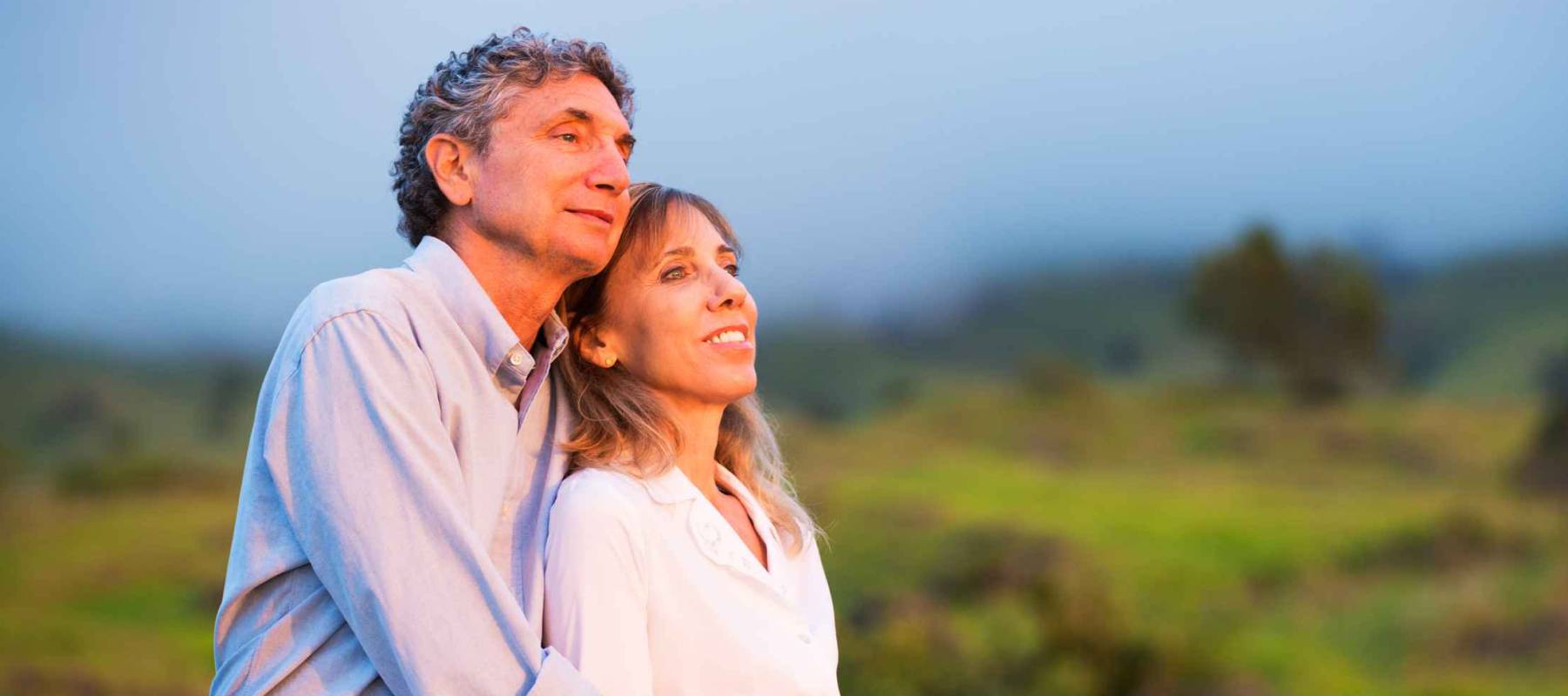 Mature middle age couple in love watching the sunset