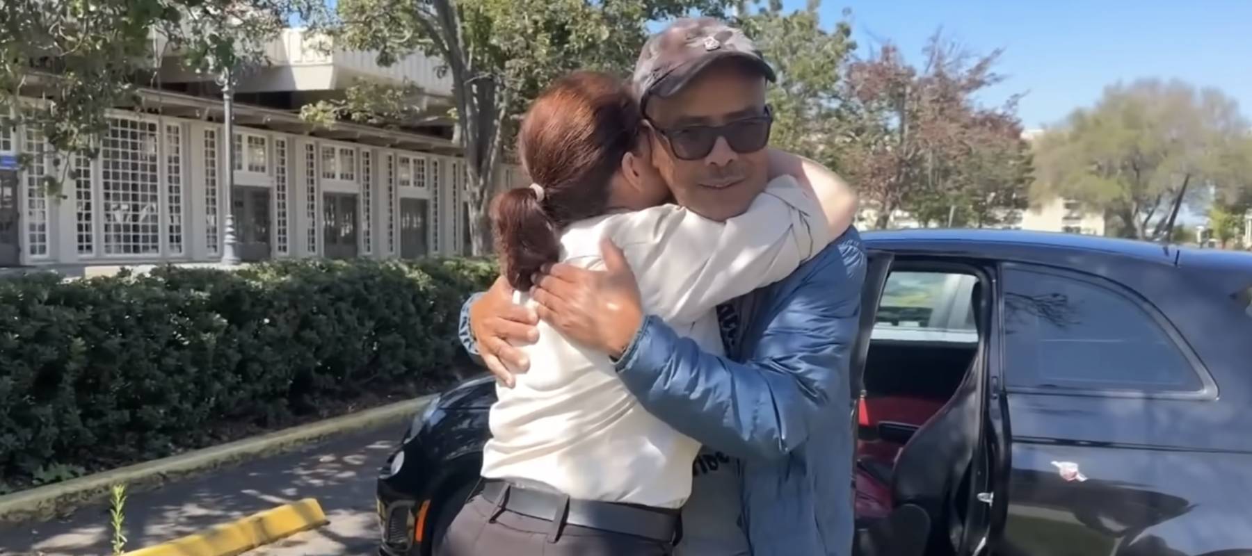 Egigu Lemma hugs his colleague after the closure of Hilton Oakland Airport.