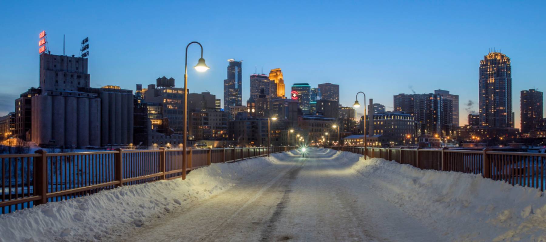 A Wide Cityscape Shot of Minneapolis during a Winter Twilight taken from the Stone Arch Bridge