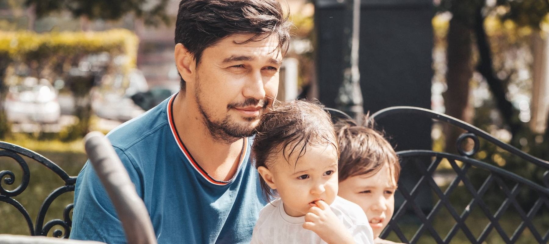 dad on a walk with his sons in the park