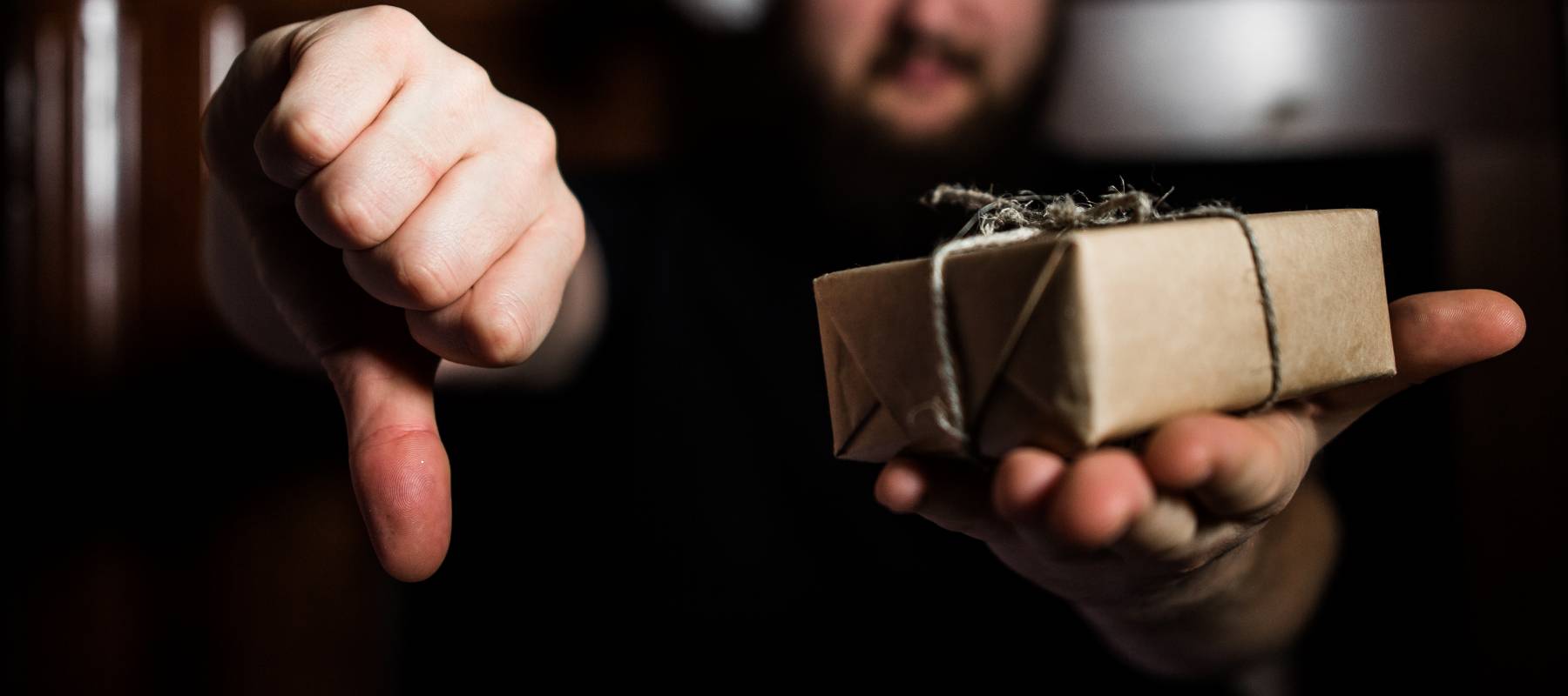 Man giving a gift thumbs down