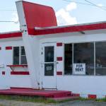 Rundown abandoned red and white roadside diner.