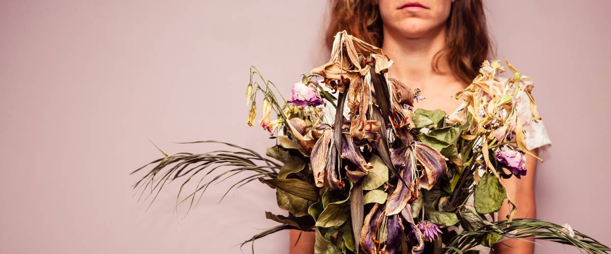 woman with dead flowers