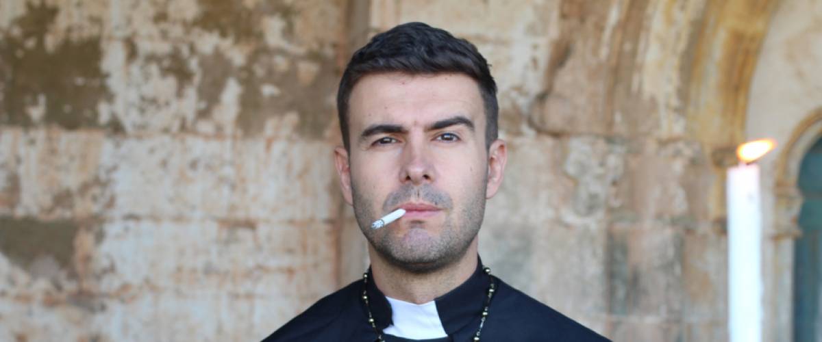 priest smoking a cigarette