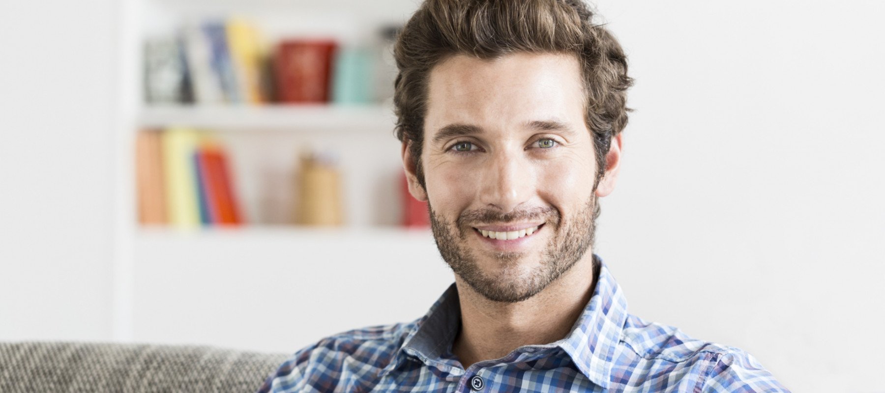 Cheerful bearded 30 year old man portrait in modern house