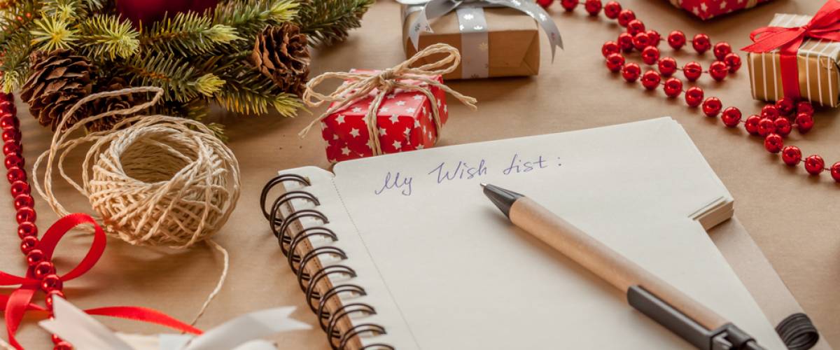 Blank journal surrounded by Christmas gifts