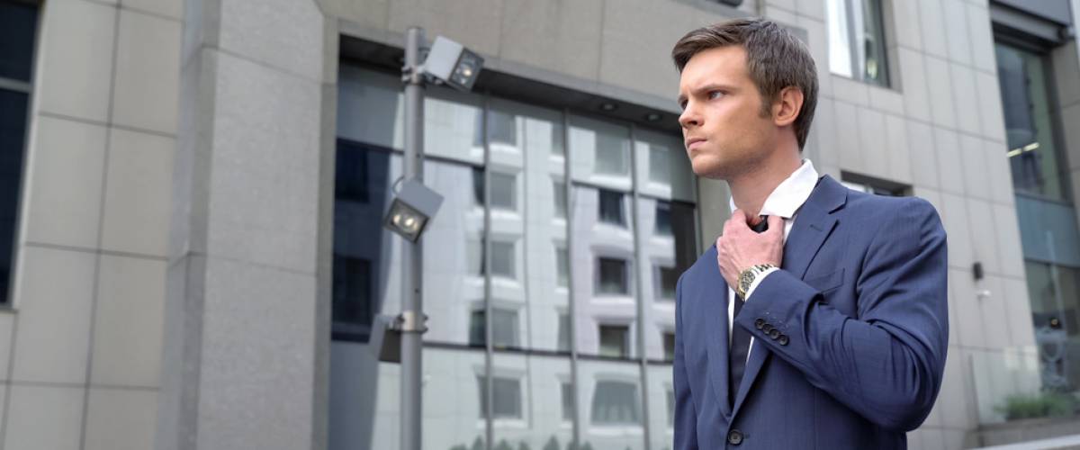 angry Caucasian businessman leaving office building