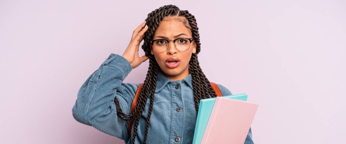 Black woman screaming with hands up in the air