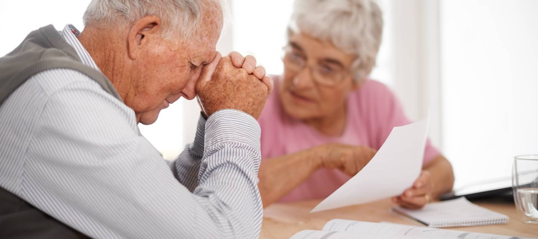 Senior man and woman going over paper documents