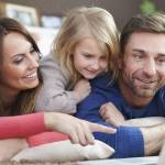Young family looking at laptop together