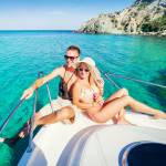 Romantic happy couple in love relaxing on a yacht at sea