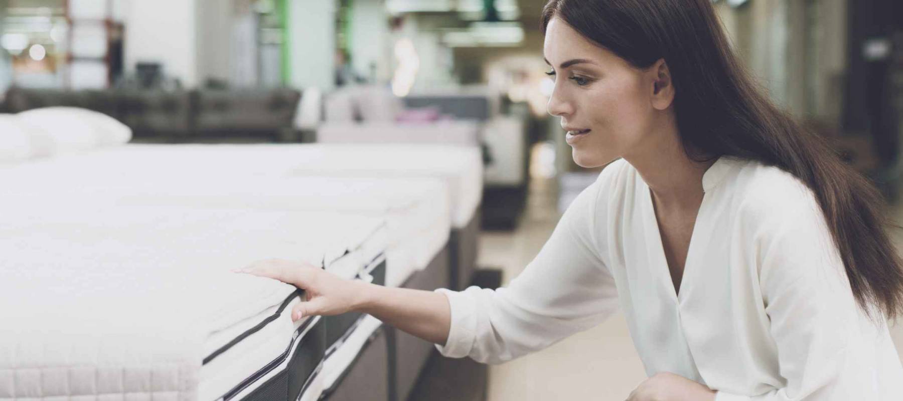 Woman shopping for a new mattress in a store