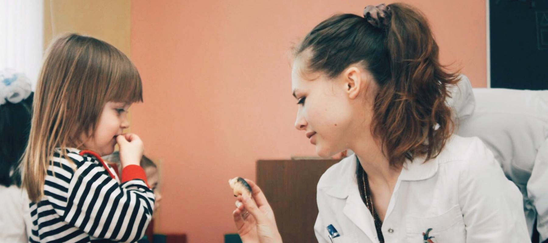 Doctor working with child