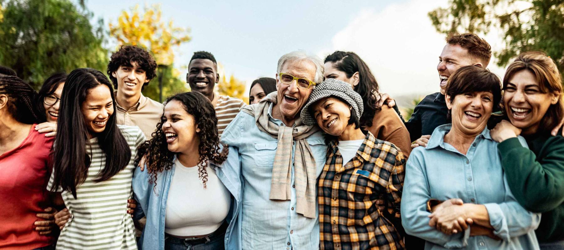 diverse and multigenerational people having fun together in a public park