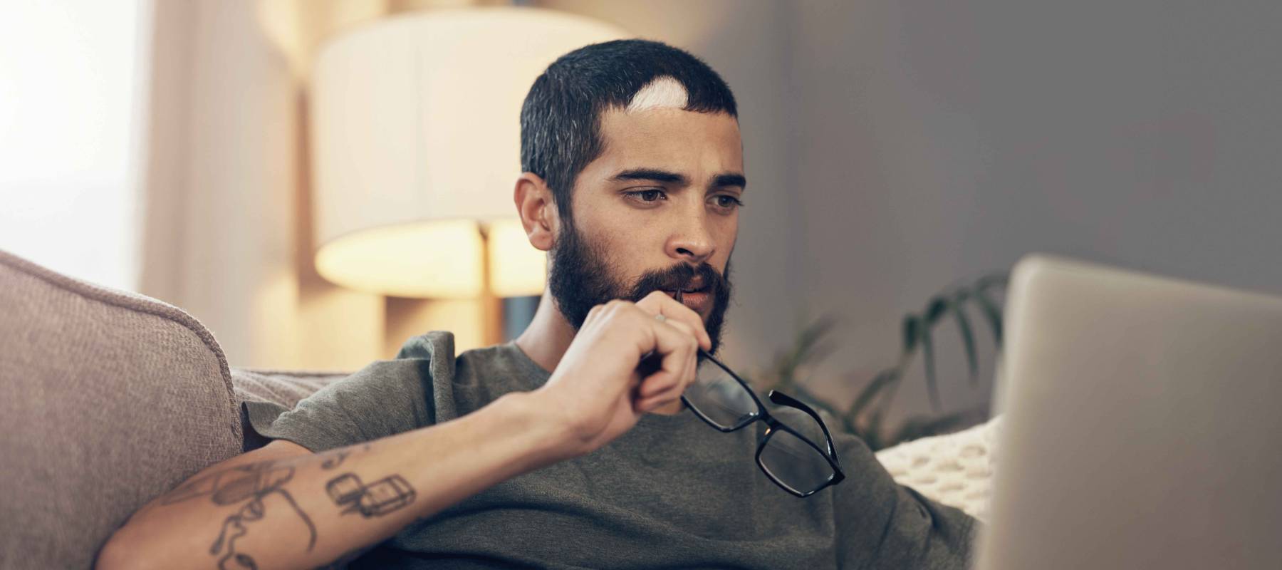 young man using a laptop on the sofa at home