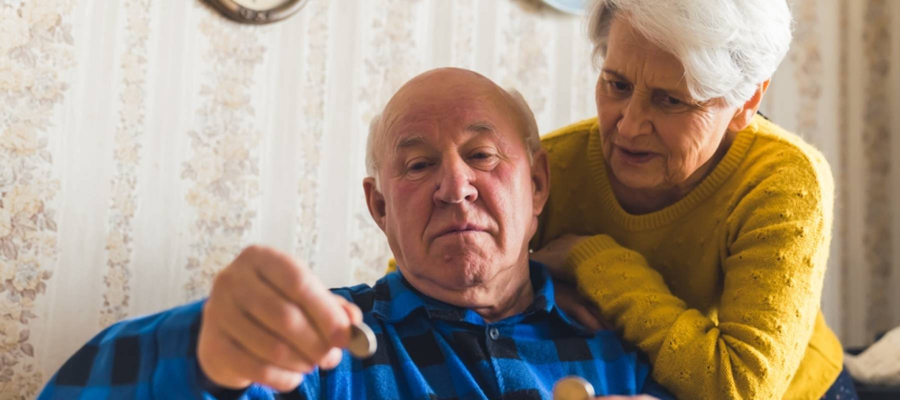 senior couple counting last cents medium shot living room money concept.