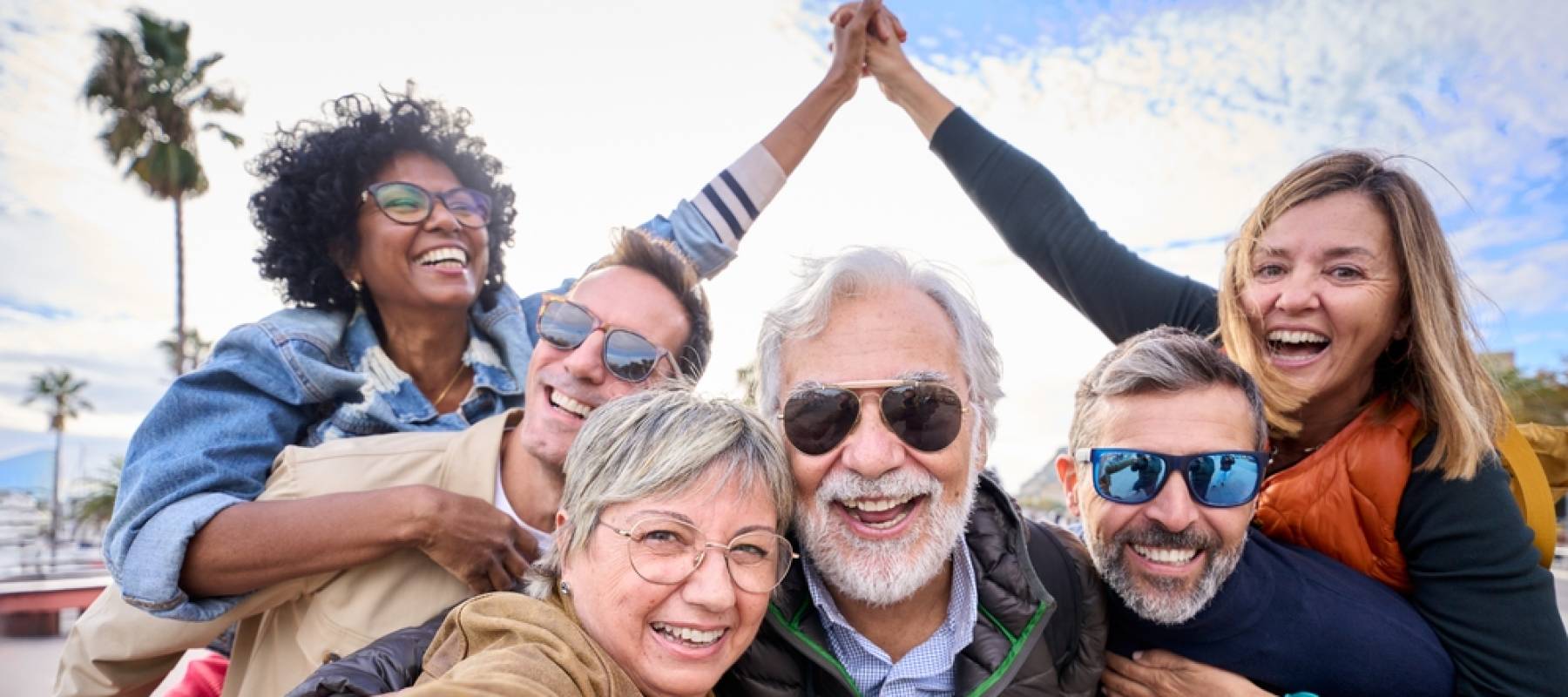 Group diverse funny mature tourist friends