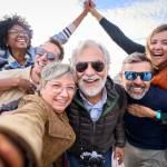 Group diverse funny mature tourist friends