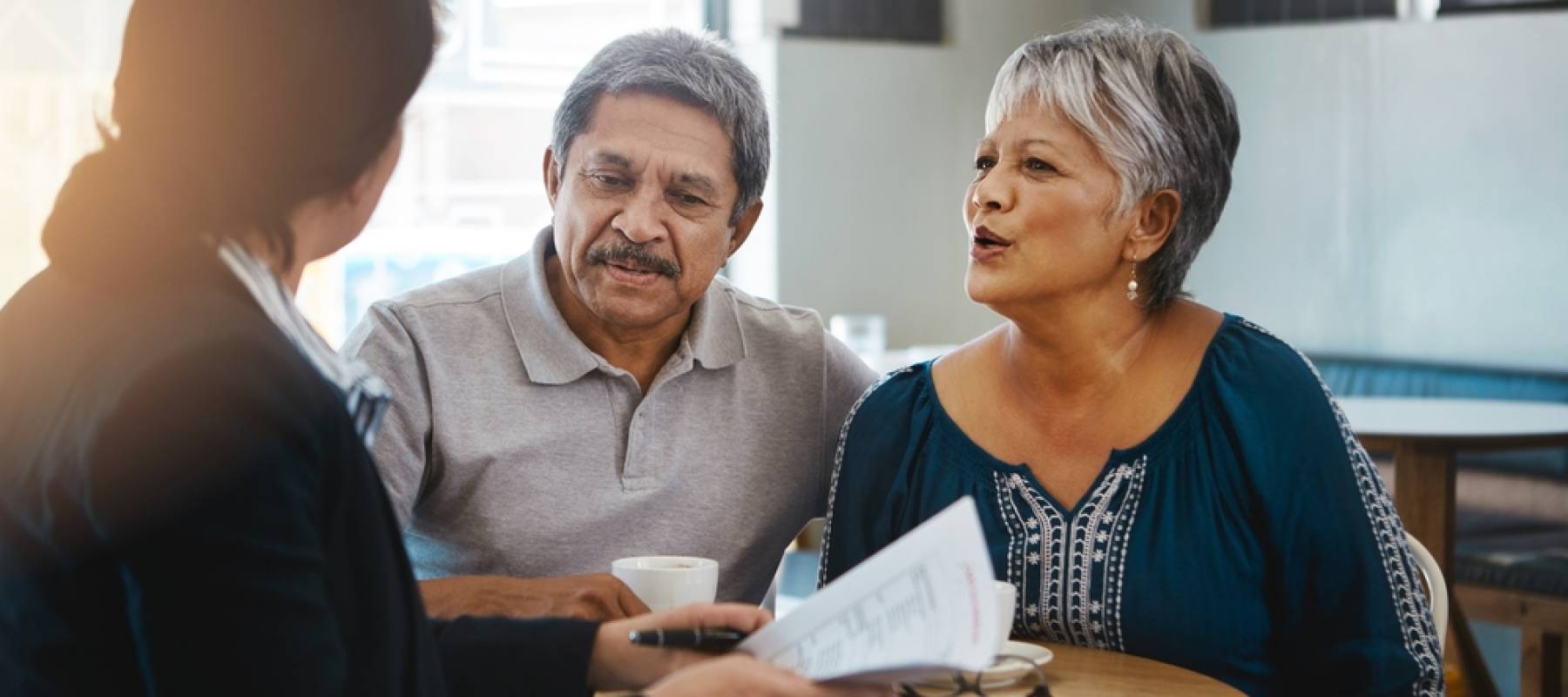 Middle aged couple speaking with a financial advisor