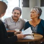 Middle aged couple speaking with a financial advisor