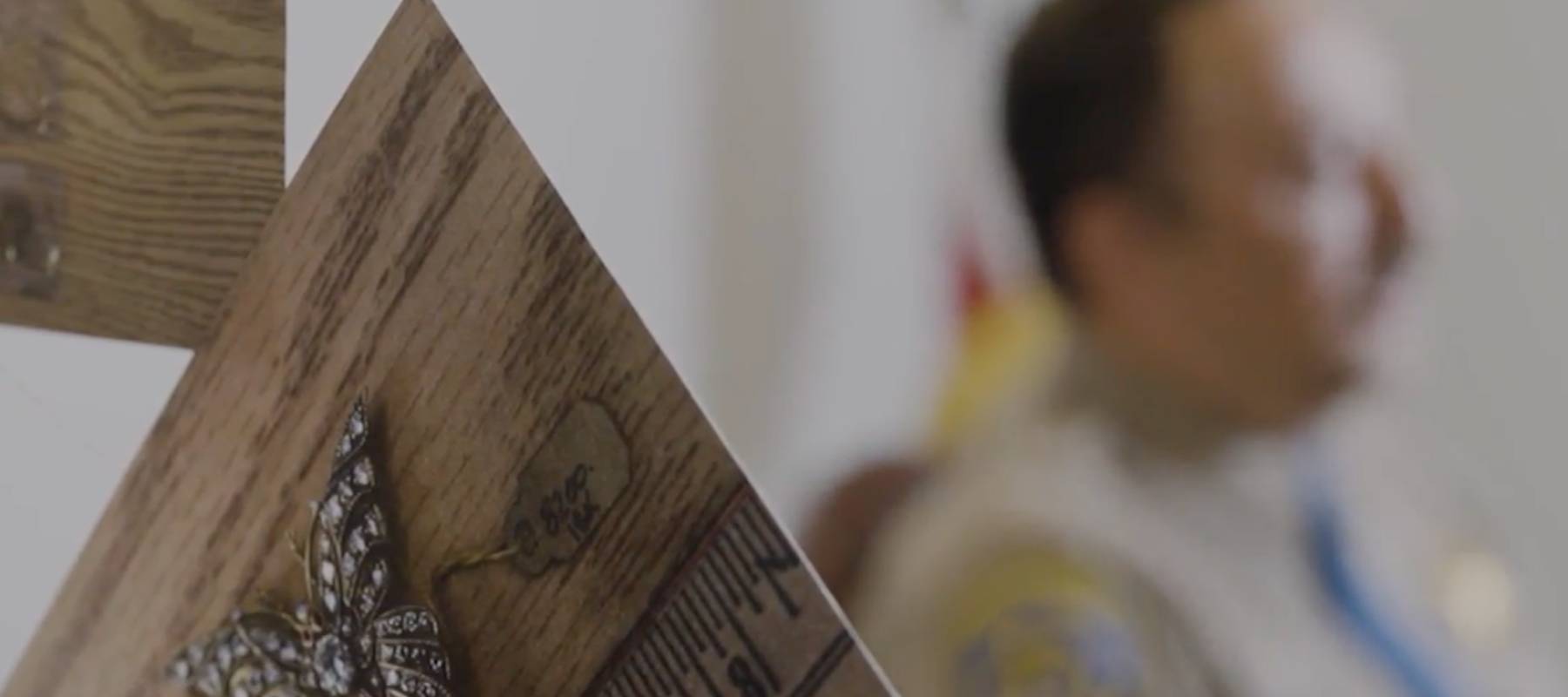 Photo of diamond broach with police officer seen in background.