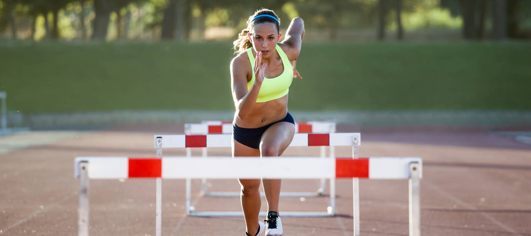 An athlete jumping over hurdles.