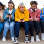 Group of teens on their phones.