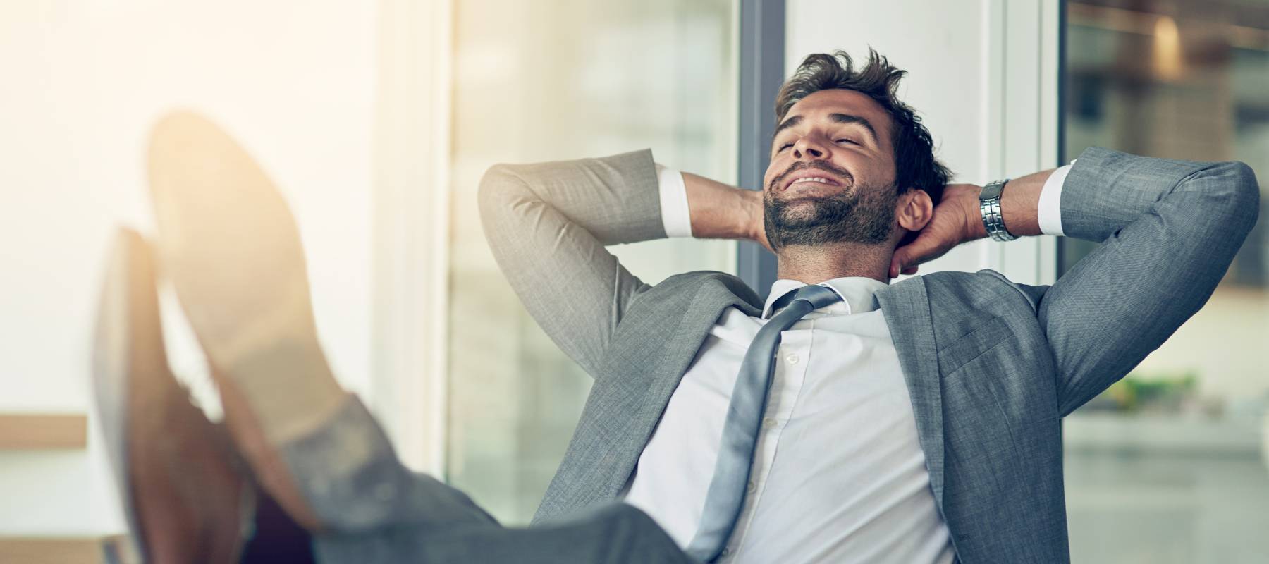 A businessman relaxes at work.